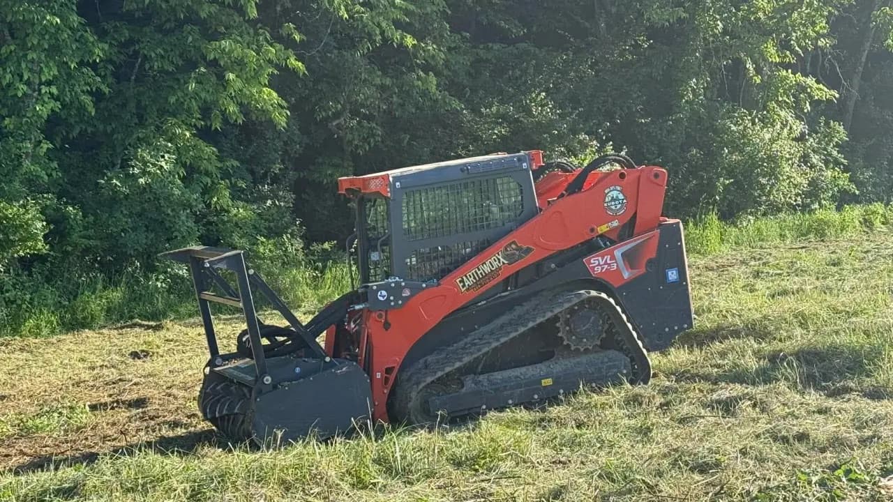 EarthWorx's branded forestry mulcher at the edge of a cleared field